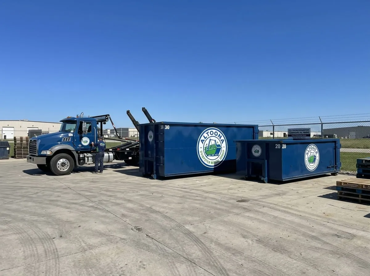 Altoona Dumpster Rental Group roll-off container and truck working a job in Blair County
